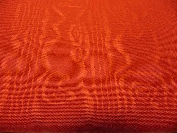 A worsted baize, embossed with a bark moiré. This is a drapery and upholstery fabric in a deep, rich cinnabar color. It is being used as drapery in Liberty Hall in Frankfort, Kentucky. We've woven it in two weights: a single baize and a double baize.
